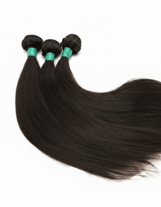 Three bundles of straight black hair with green clips on a white background